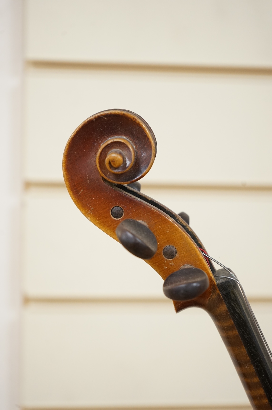 Five cased 20th century violins, including; a German violin, two Czech violins, a three-quarter size violin with a label for Bienfait, and a Romanian quarter size violin, all in cases or the remains of cases.